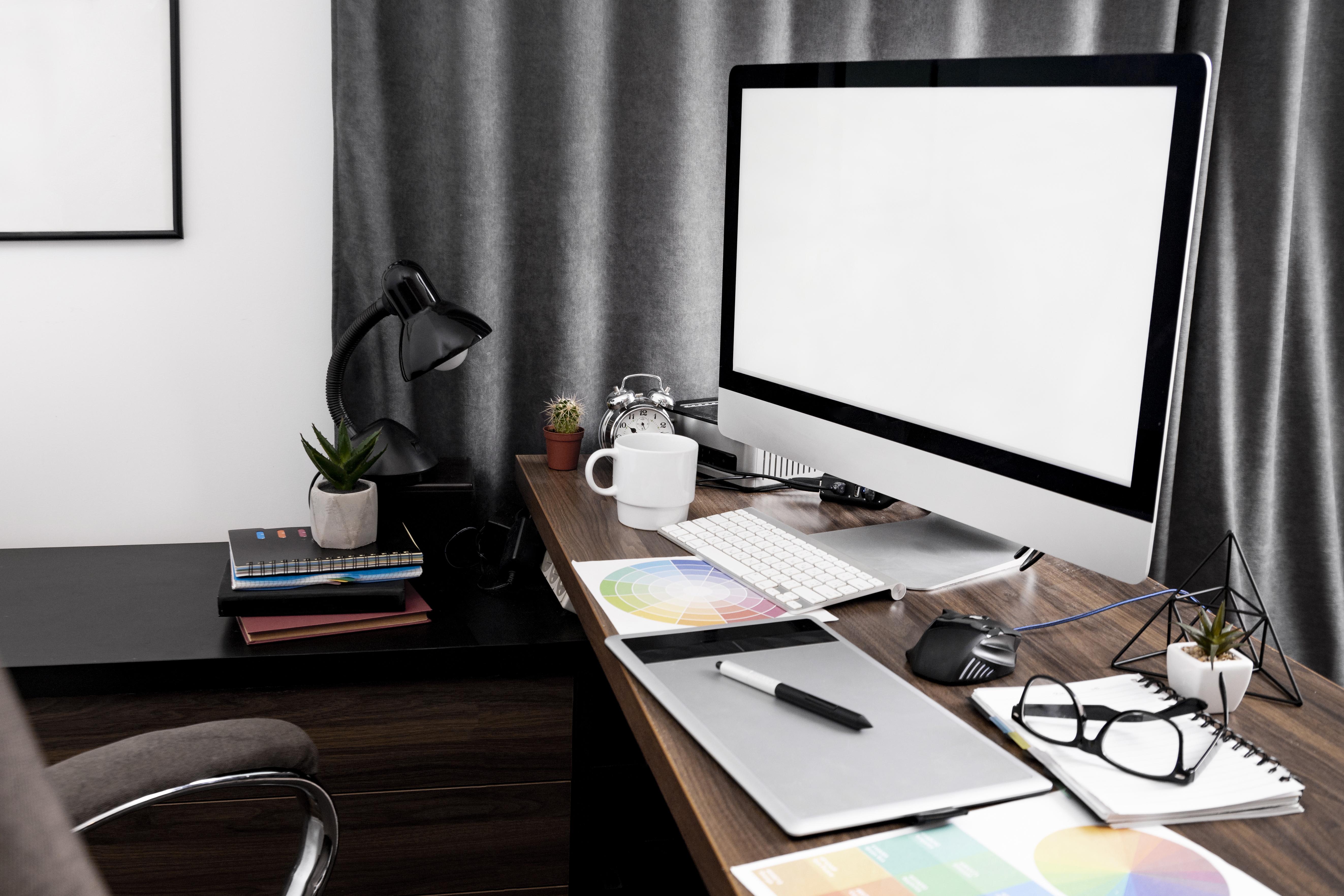 Sam Digital Creations creative workspace with laptop, tablet, and design tools